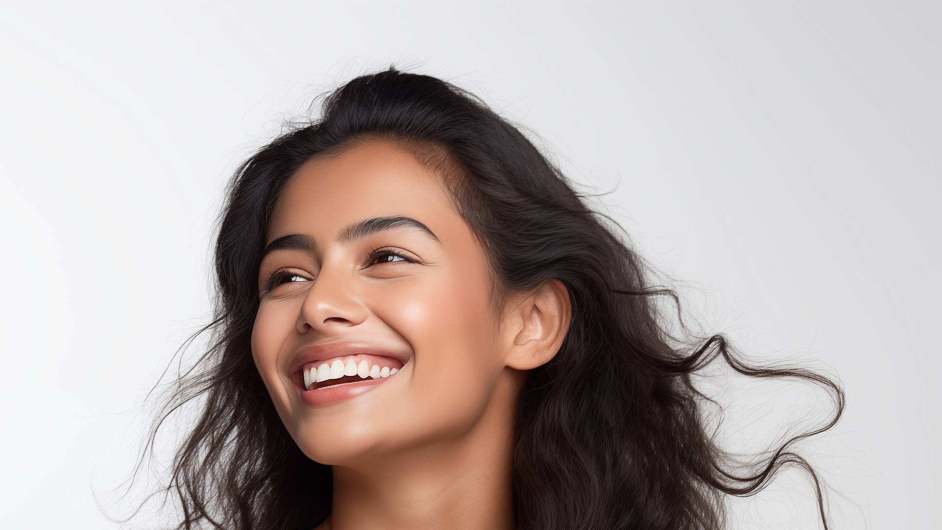 A smiling woman with fresh, glowing skin